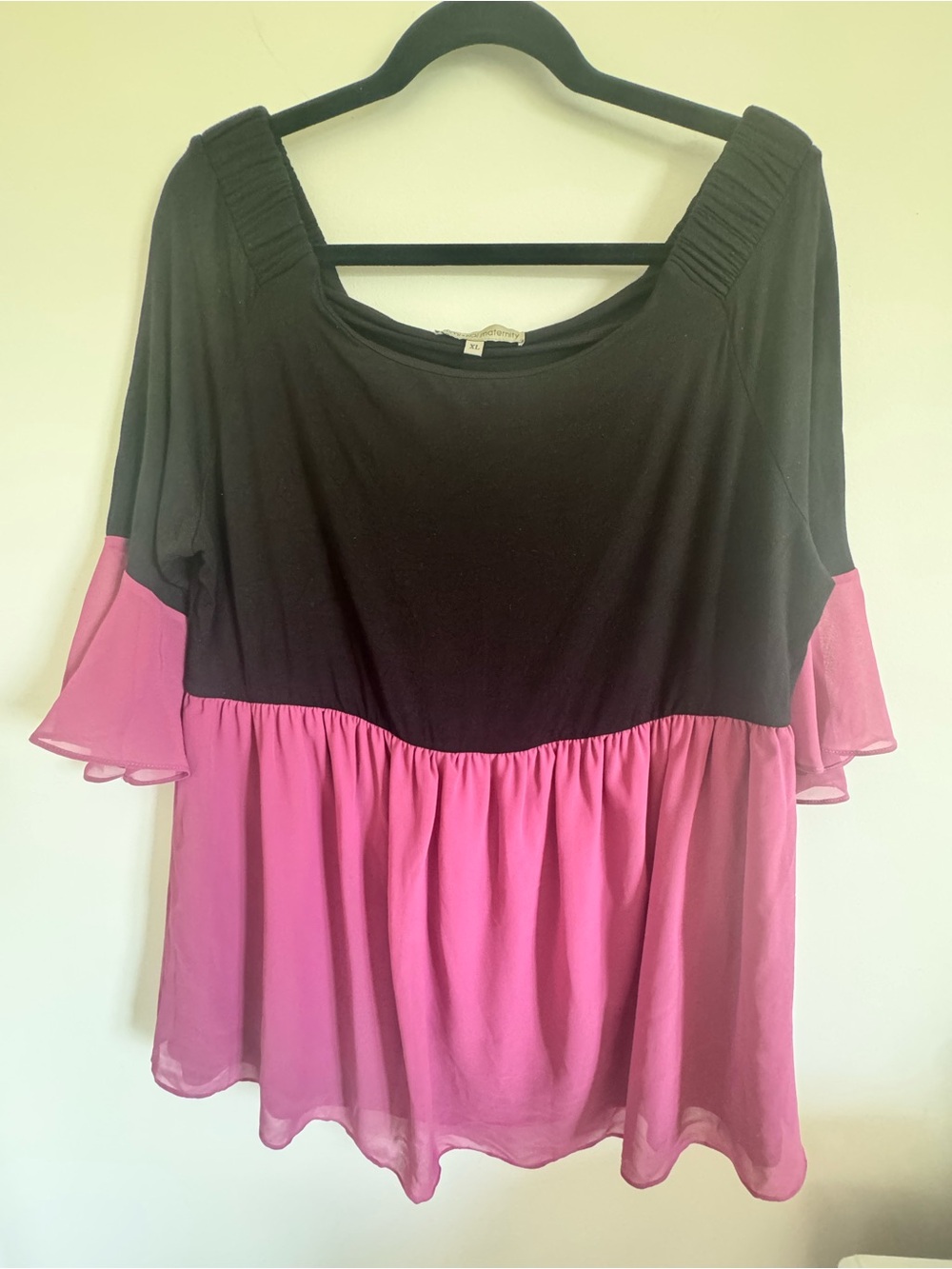Kimi and Kai Black Top with Pink Ruffle Hem and Flutter Sleeves